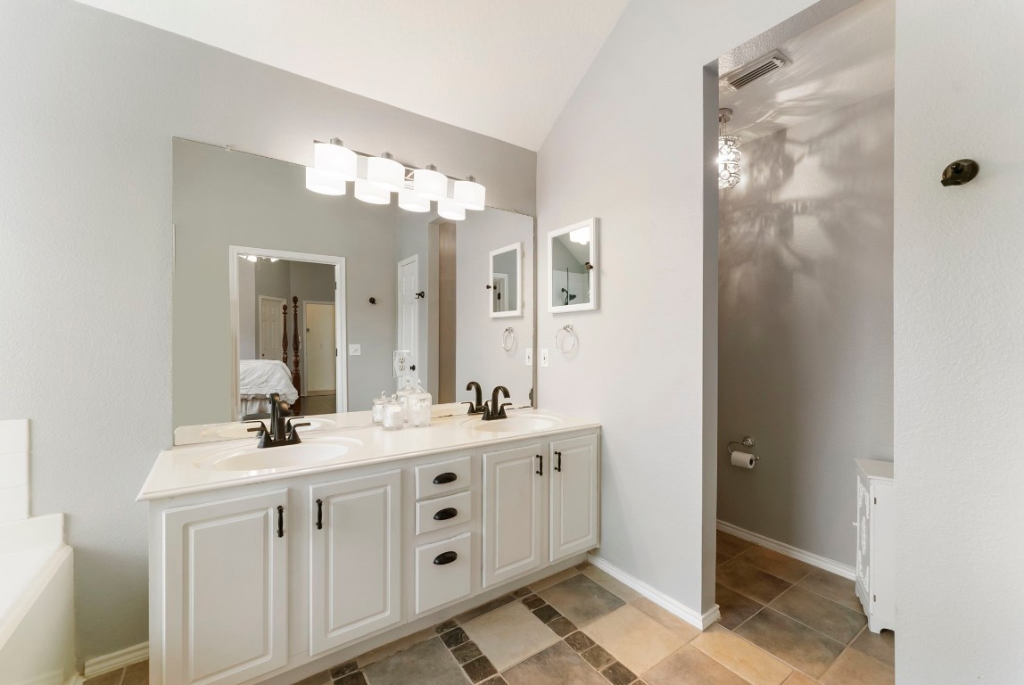 2015 Louetta Brook Court Spring, TX 77388 - Photo 17 of 28 a bathroom with a double vanity sink a mirror and a shower