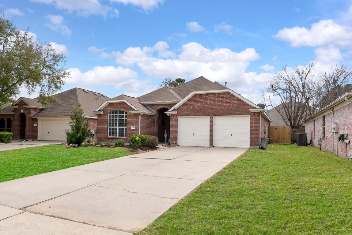 2015 Louetta Brook Court Spring, TX 77388 - Photo 28 of 28 a front view of a house with a yard and garage