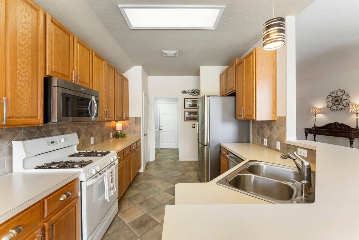 2015 Louetta Brook Court Spring, TX 77388 - Photo 6 of 28 a kitchen with a sink a stove and cabinets