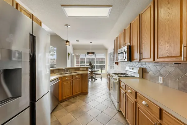 a large kitchen with stainless steel appliances lots of counter top space