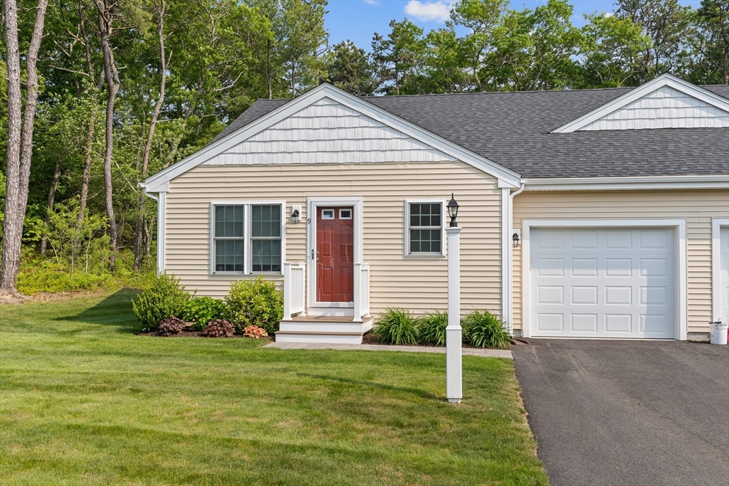 a view of a house with a yard and plants