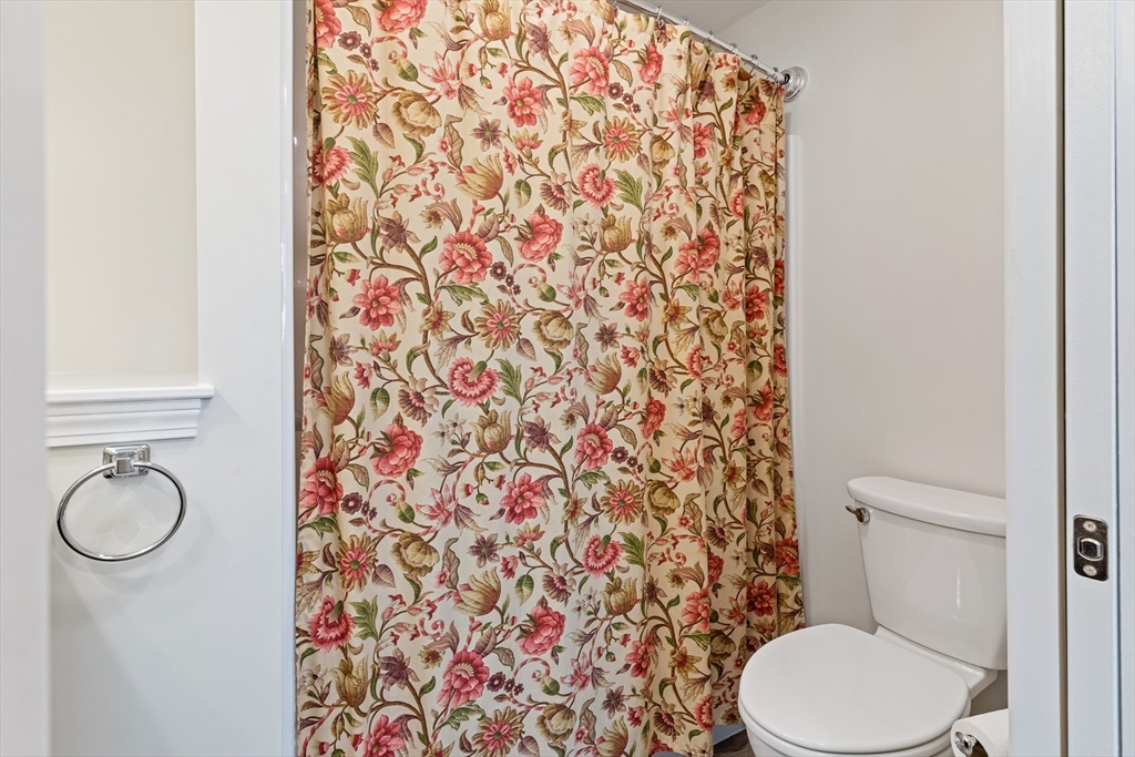 9 Tupper Hill Road, Unit 9 Plymouth, MA 02360 - Photo 16 of 30 a white toilet sitting next to a shower curtain