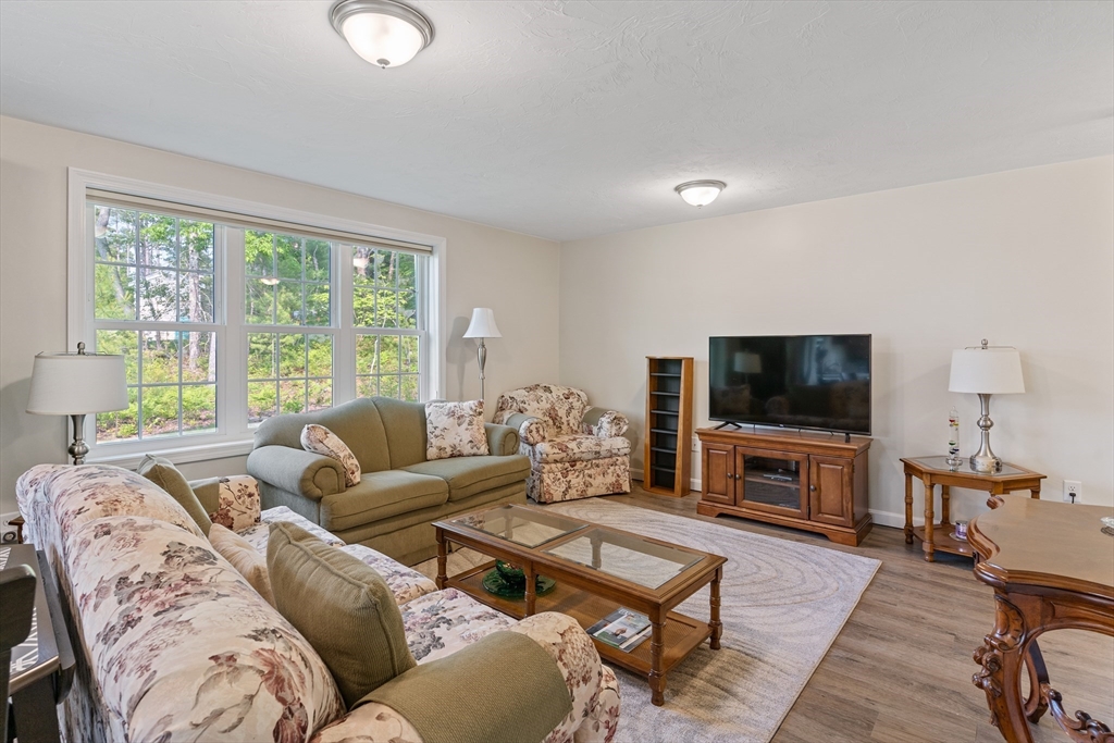 9 Tupper Hill Road, Unit 9 Plymouth, MA 02360 - Photo 21 of 30 a living room with furniture and a flat screen tv