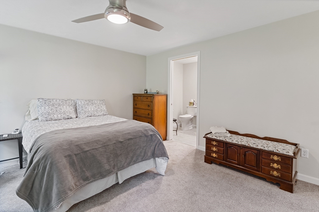 9 Tupper Hill Road, Unit 9 Plymouth, MA 02360 - Photo 22 of 30 a bedroom with a bed and a chandelier