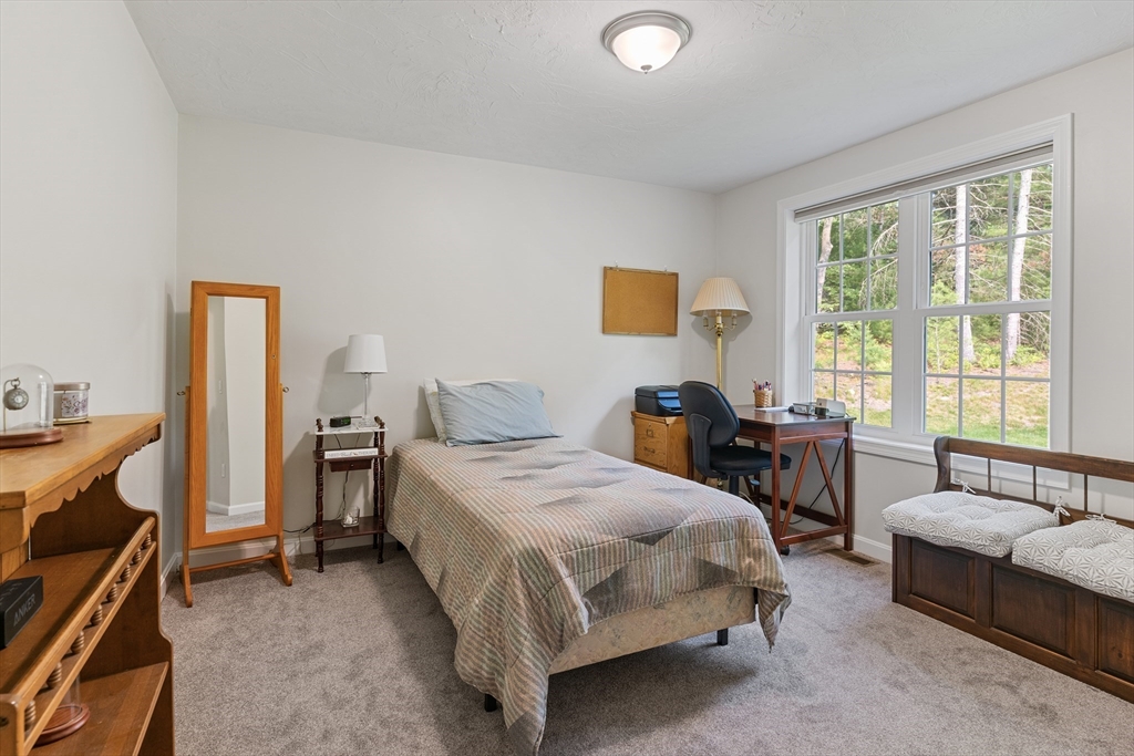 9 Tupper Hill Road, Unit 9 Plymouth, MA 02360 - Photo 26 of 30 a bedroom with a bed and a couch