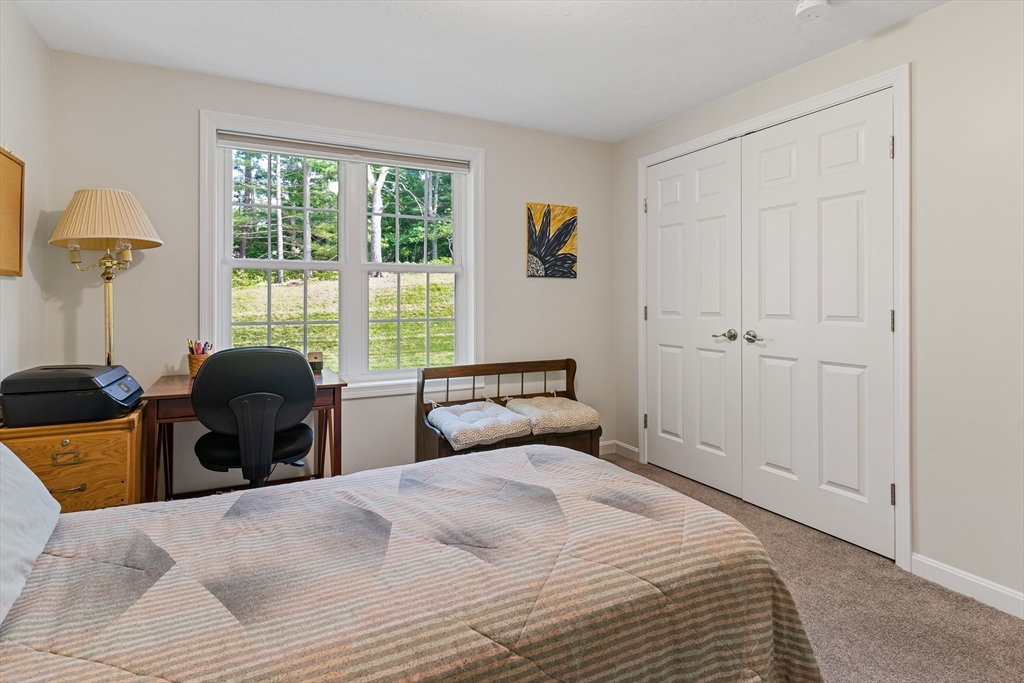 9 Tupper Hill Road, Unit 9 Plymouth, MA 02360 - Photo 27 of 30 a bedroom with a bed and a large window