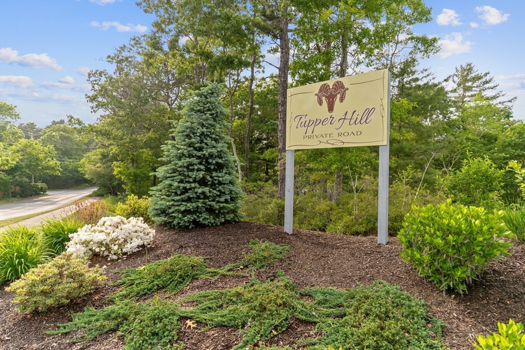 9 Tupper Hill Road, Unit 9 Plymouth, MA 02360 - Photo 9 of 30 a sign that is sitting in front of flowers