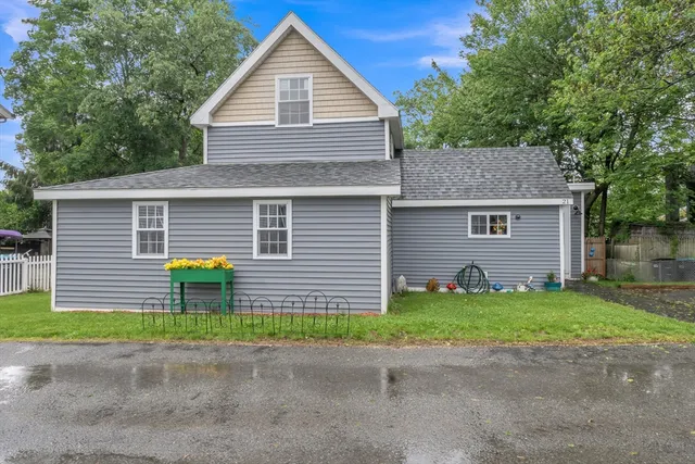 a view of a backyard with plants and a garage
