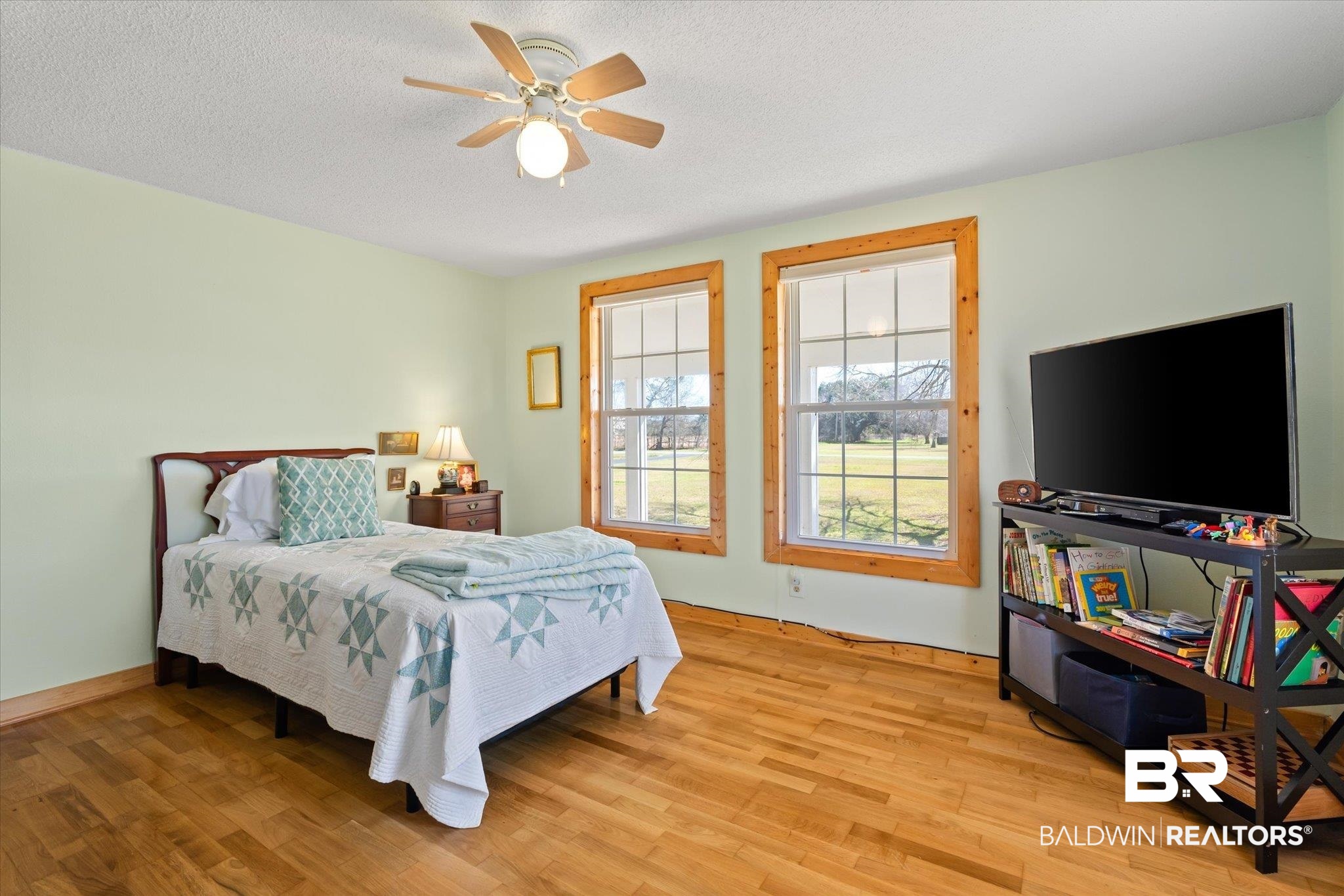 14280 Cat Deakle Road Grand Bay, AL 36541 - Photo 18 of 51 Bedroom featuring light wood finished floors, ceiling fan, and a textured ceiling