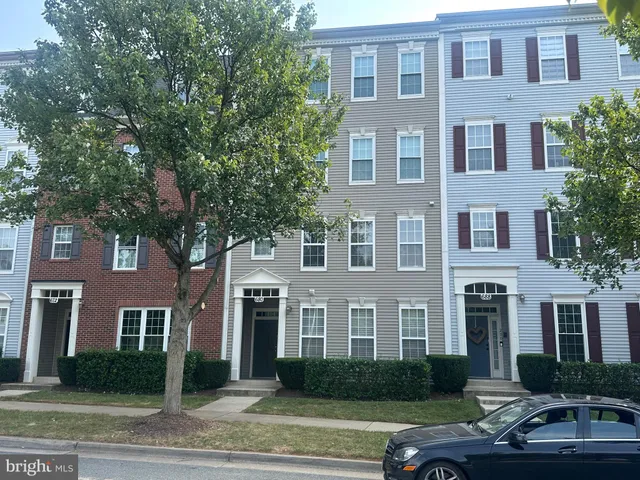 a front view of a house with yard and green space