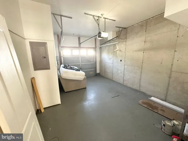 a front view of a building with lot of cars and trees