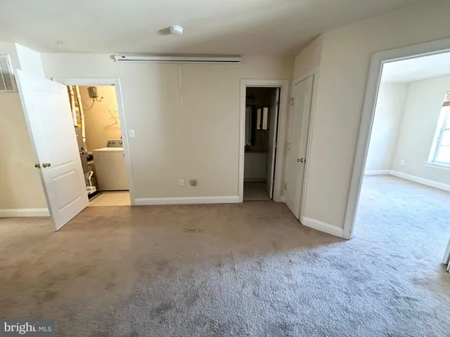 a view of a livingroom with wooden floor and stairs
