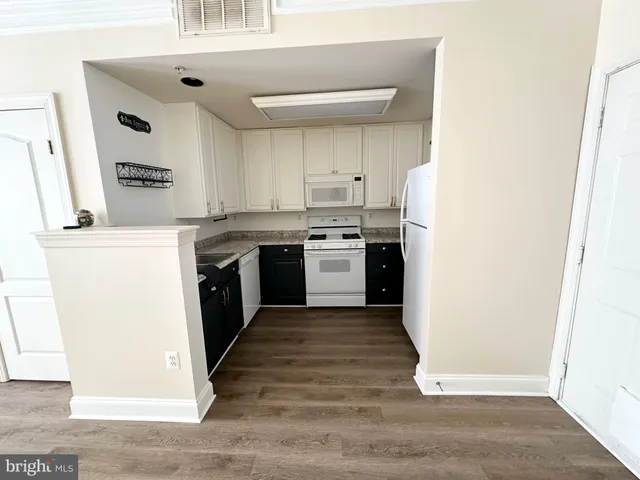 a kitchen with stainless steel appliances granite countertop a stove top oven and sink