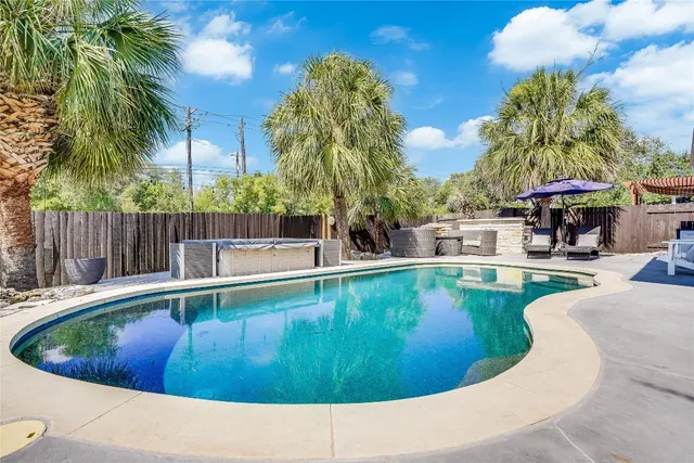 a view of a swimming pool with a patio