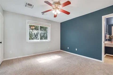 a view of a patio with chairs and potted plants