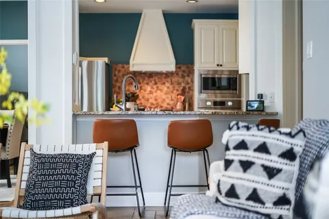 a kitchen with stainless steel appliances granite countertop a stove and a refrigerator