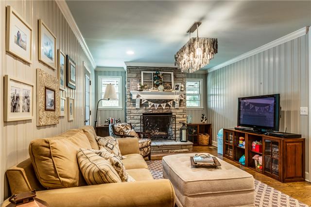 9550 Mullins Road Arrington, TN 37014 - Photo 7 of 20 Cozy living room off the kitchen area with a stone fireplace and access to the deck