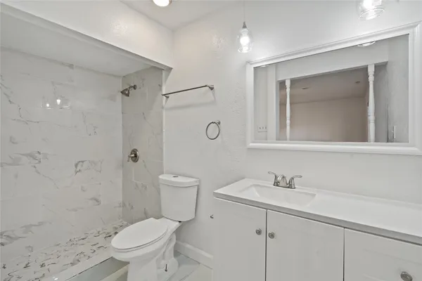 a bathroom with a sink toilet and shower