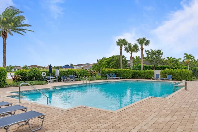 an aerial view of residential houses with outdoor space and ocean view