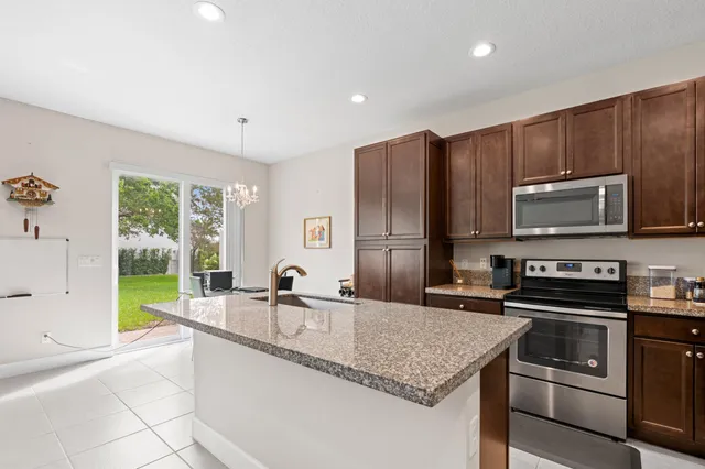 a kitchen with a sink a stove and cabinets