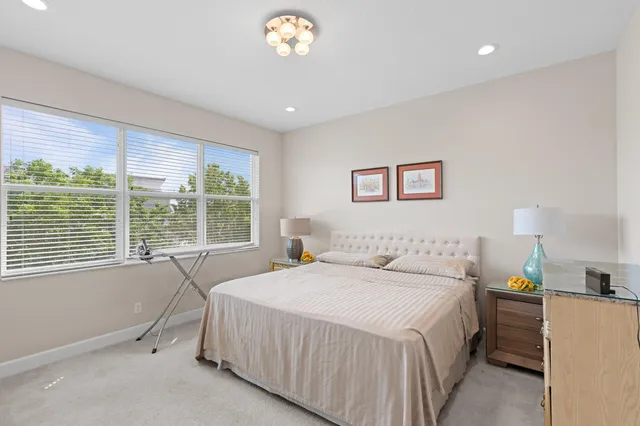 a bedroom with a bed and a large window