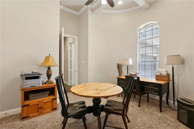 a view of a dining room with furniture and chandelier