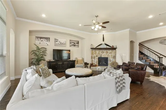 a living room with furniture a fireplace and a flat screen tv
