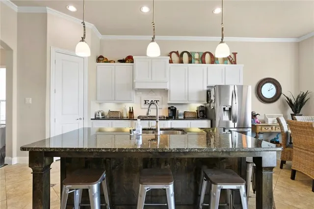 a kitchen with kitchen island granite countertop a table and chairs in it