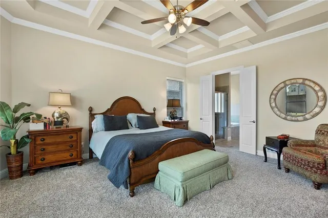 a spacious bedroom with a bed a couch and dresser