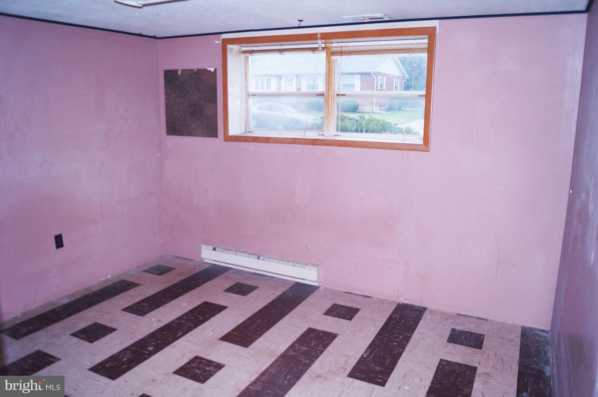1319 Denbright Road Baltimore, MD 21228 - Photo 8 of 11 a bedroom with a bed and a window