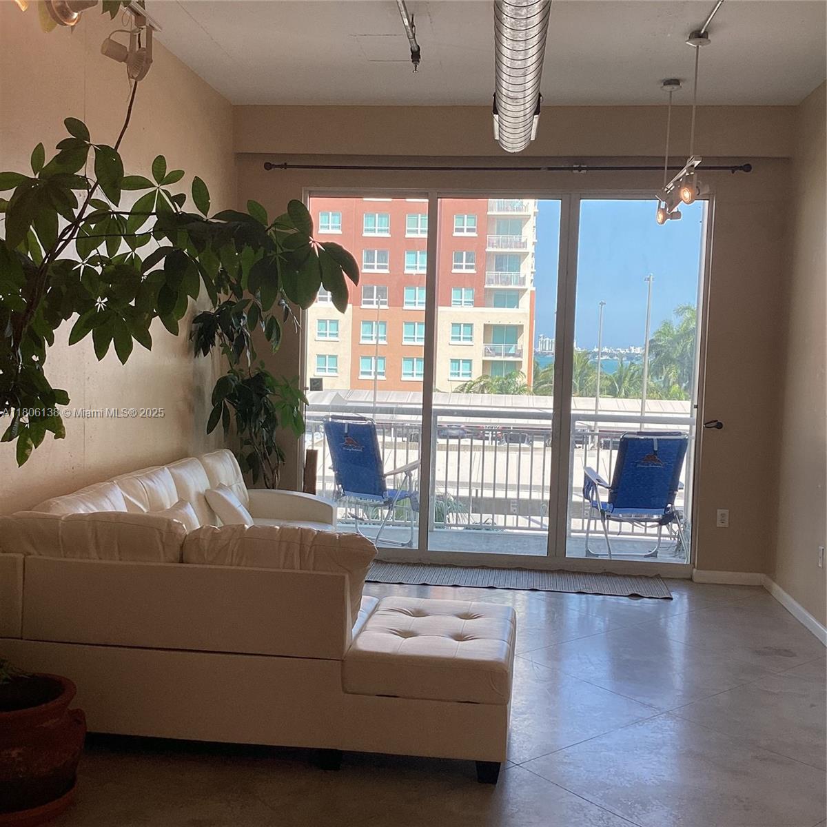 2001 Biscayne Boulevard, Unit 3503 Miami, FL 33137 - Photo 12 of 34 a living room with furniture and a floor to ceiling window