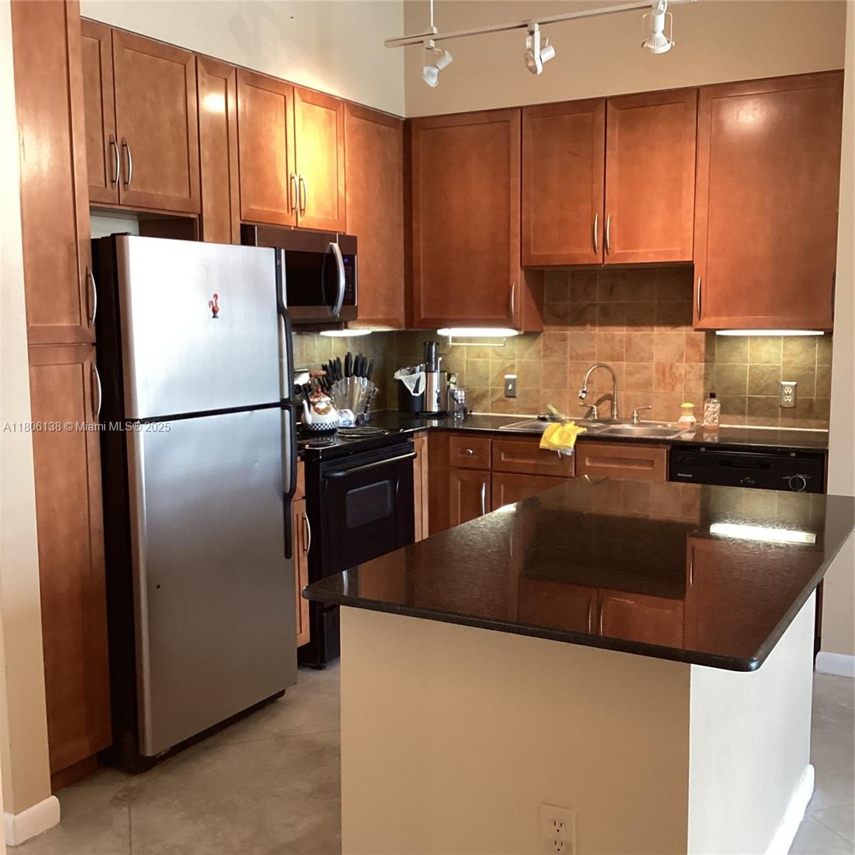 2001 Biscayne Boulevard, Unit 3503 Miami, FL 33137 - Photo 14 of 34 a kitchen with granite countertop stainless steel appliances a refrigerator and a sink