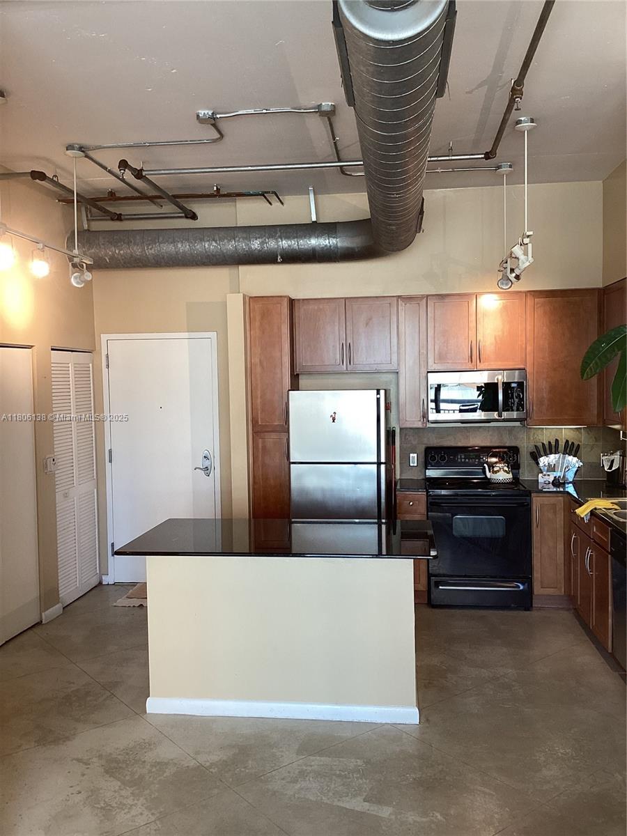 2001 Biscayne Boulevard, Unit 3503 Miami, FL 33137 - Photo 16 of 34 a kitchen with stainless steel appliances granite countertop a stove a sink and a refrigerator