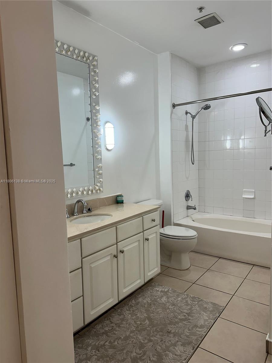 2001 Biscayne Boulevard, Unit 3503 Miami, FL 33137 - Photo 19 of 34 a bathroom with a double vanity sink toilet mirror and bathtub