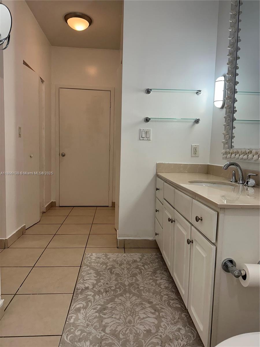 2001 Biscayne Boulevard, Unit 3503 Miami, FL 33137 - Photo 22 of 34 a bathroom with a sink and a mirror