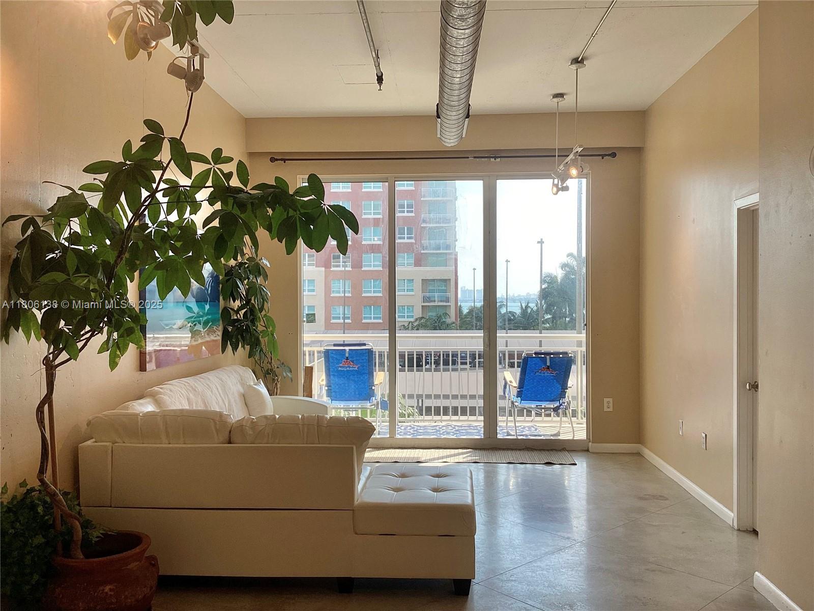 2001 Biscayne Boulevard, Unit 3503 Miami, FL 33137 - Photo 10 of 34 a living room with furniture and a potted plant