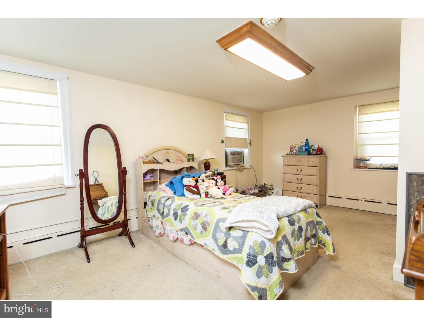 291 New Garden Road Avondale, PA 19311 - Photo 21 of 25 a bedroom with a bed a dresser and mirror