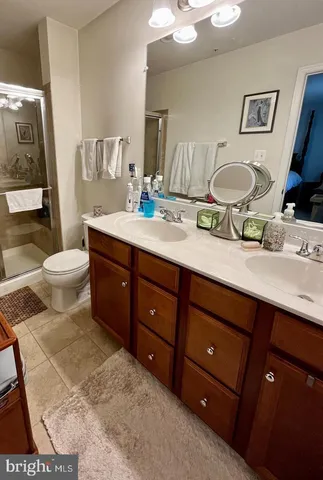 a bathroom with a sink vanity granite and toilet