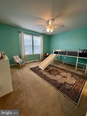 a bed sitting in a room next to a window
