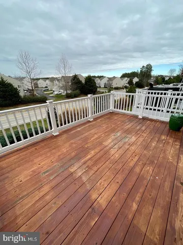 a view of deck with wooden floor and fence