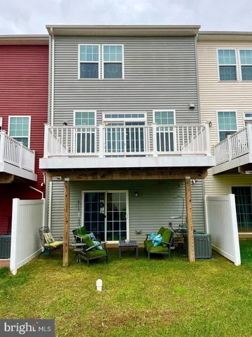 a view of a house with pool and chairs
