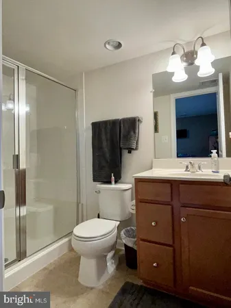 a bathroom with a toilet a sink and a mirror