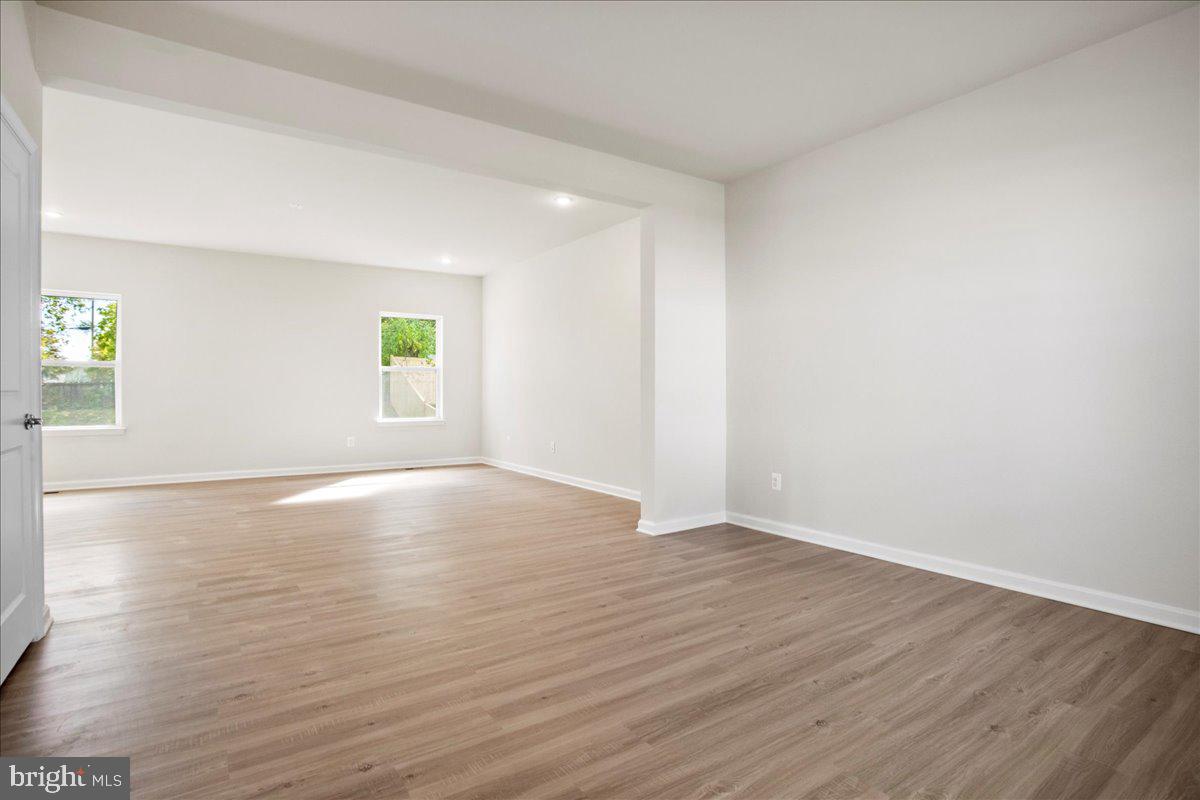 112 Spade End Road Inwood, WV 25428 - Photo 5 of 35 an empty room with wooden floor and windows