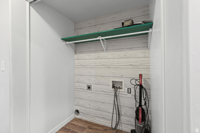 652 West 800 North, Unit 45 Clinton, UT 84015 - Photo 11 of 17 Utility closet featuring wood-finish flooring, shiplap-style wall paneling, and a mounted storage shelf