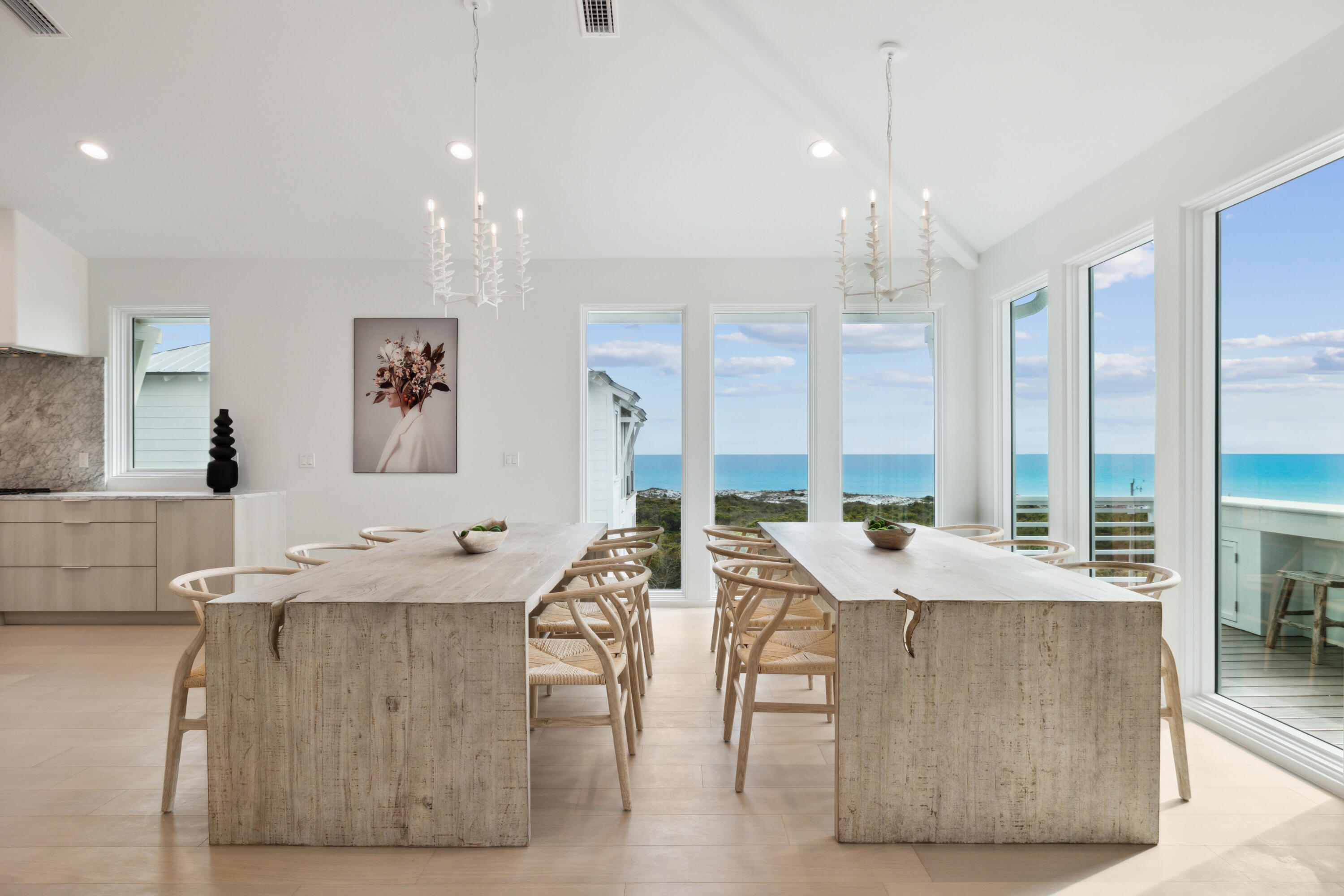 a large kitchen with kitchen island a large counter top space a sink stainless steel appliances and windows