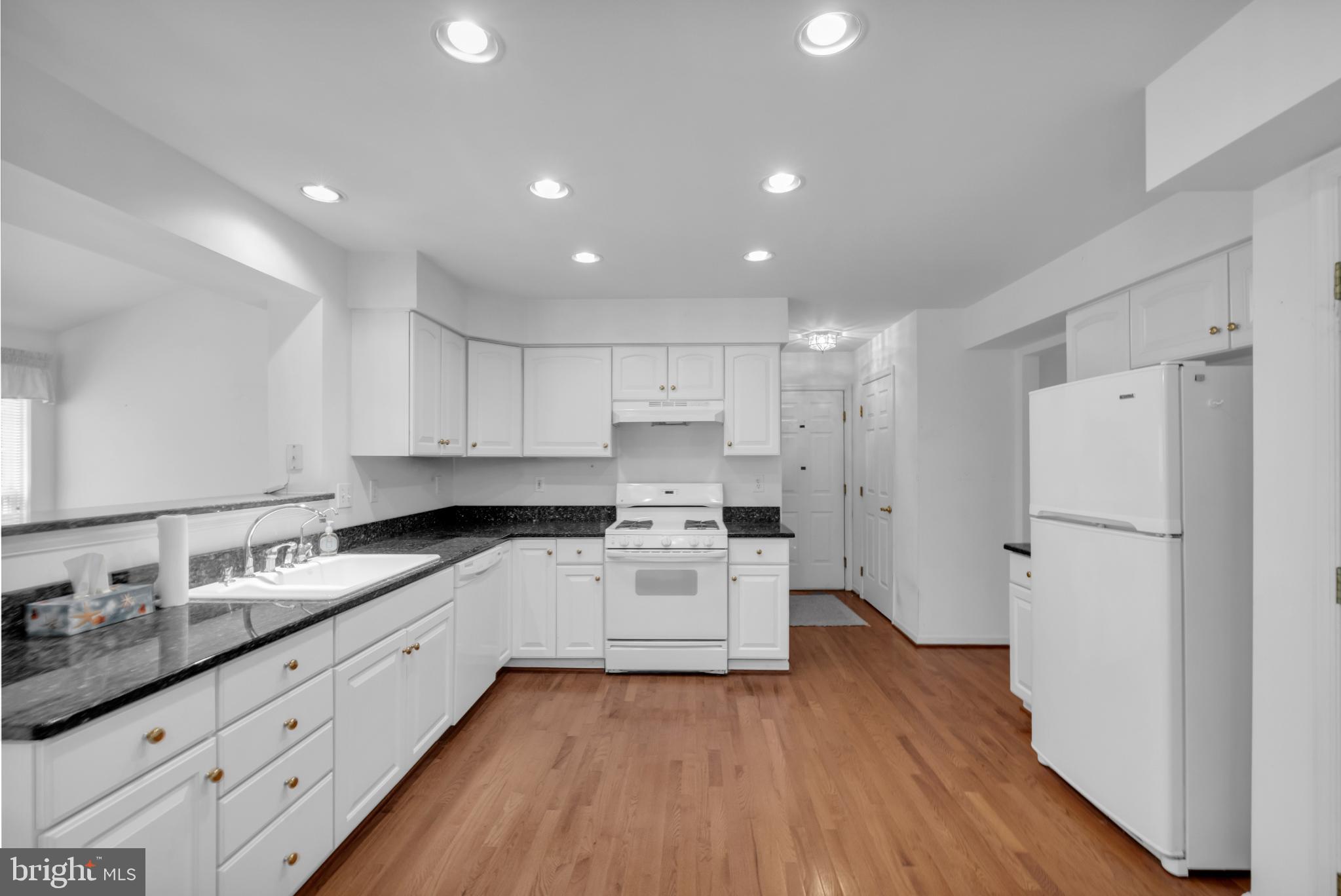 5184 Lovering Drive Doylestown, PA 18902 - Photo 8 of 51 a kitchen with white cabinets and white appliances