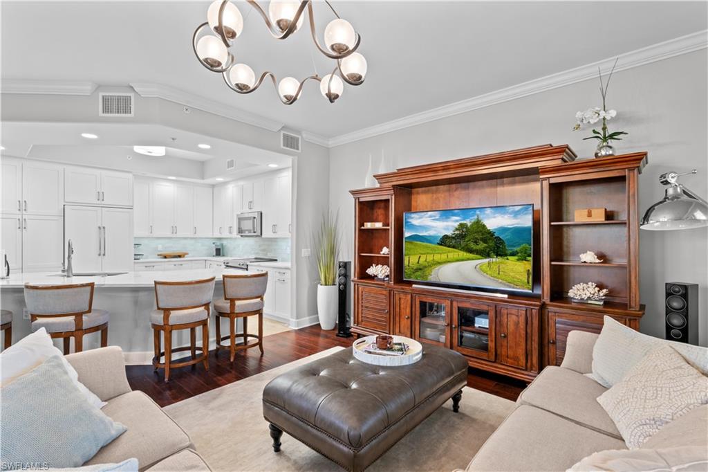 1104 6th Street South, Unit 1 Naples, FL 34102 - Photo 12 of 40 Living room featuring crown molding, dark wood-style flooring, a chandelier, and recessed lighting
