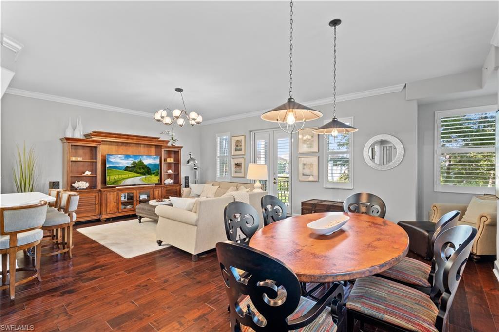 1104 6th Street South, Unit 1 Naples, FL 34102 - Photo 17 of 40 Dining area with dark wood finished floors, healthy amount of natural light, a chandelier, and ornamental molding