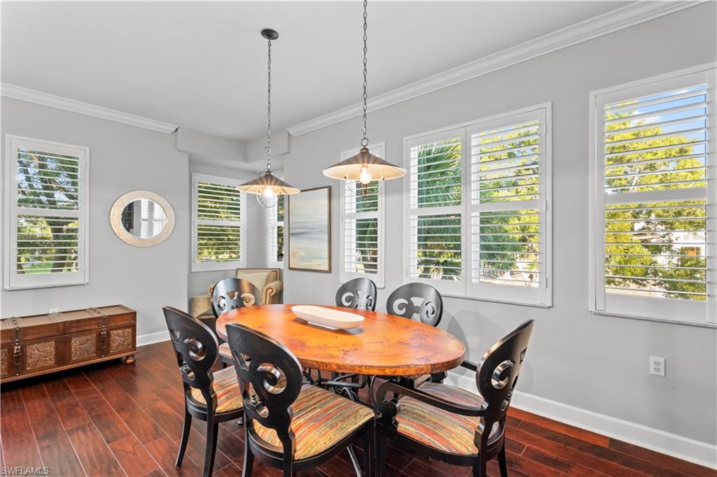 1104 6th Street South, Unit 1 Naples, FL 34102 - Photo 18 of 40 Dining space with crown molding, dark wood finished floors, and healthy amount of natural light