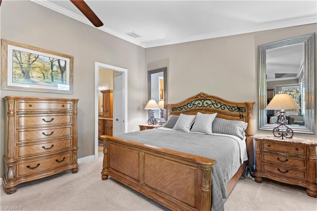 1104 6th Street South, Unit 1 Naples, FL 34102 - Photo 24 of 40 Bedroom featuring light carpet, ornamental molding, connected bathroom, and a ceiling fan